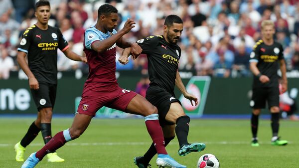 West Ham United's French striker Sebastien Haller (L) battles with Manchester City's Algerian midfielder Riyad Mahrez (R) during the English Premier League football match between West Ham United and Manchester City at The London Stadium, in east London on August 10, 2019. (Photo by Ian KINGTON / AFP) / RESTRICTED TO EDITORIAL USE. No use with unauthorized audio, video, data, fixture lists, club/league logos or 'live' services. Online in-match use limited to 120 images. An additional 40 images may be used in extra time. No video emulation. Social media in-match use limited to 120 images. An additional 40 images may be used in extra time. No use in betting publications, games or single club/league/player publications. / 