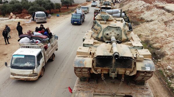 Покинувшие свои дома сирийцы и колонна турецкой военной техники в провинции Идлиб