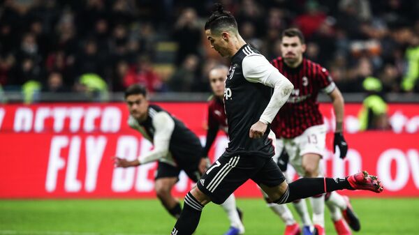 Juventus' Portuguese forward Cristiano Ronaldo shoots to score a penalty and equalize during the Italian Cup (Coppa Italia) semi-final first leg football match AC Milan vs Juventus Turin on February 13, 2020 at the San Siro stadium in Milan. (Photo by Isabella BONOTTO / AFP)