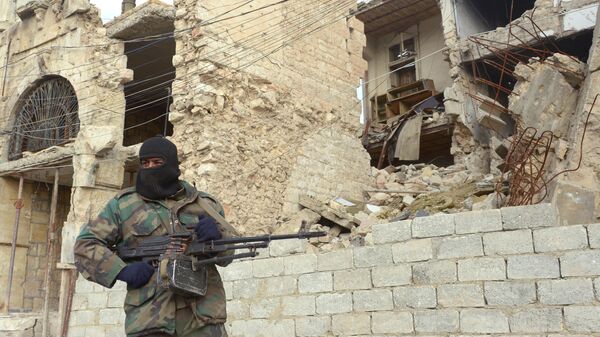 Сирийский военный рядом с разрушенным зданием в Алеппо
