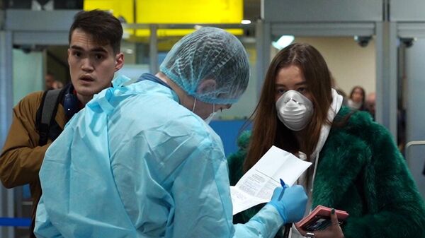 Медицинский работник проводит осмотр пассажиров в аэропорту Шереметьево