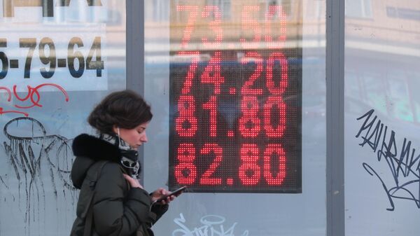 Табло курса обмена доллара и евро к рублю на одной из улиц в Москве
