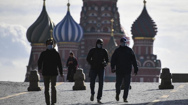 Туристы в медицинских масках на Красной площади в Москве
