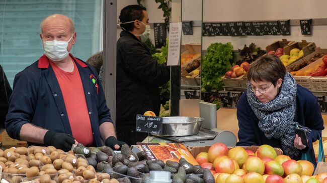 Женщина делает покупки в продуктовом магазине в Париже