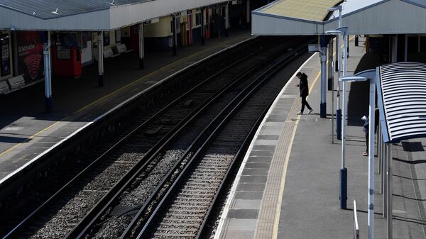 Пассажир на пустой платформе на станции Ричмонд в Лондоне