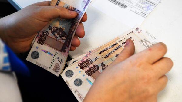 Сотрудница Почты России выдает пособие пенсионерке