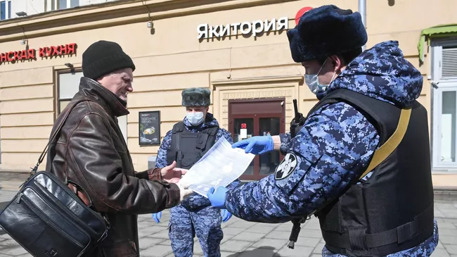 Сотрудники Росгвардии во время раздачи горожанам памяток по профилактике коронавирусной инфекции на одной из улиц в Москве Сотрудники Росгвардии во время раздачи горожанам памяток по профилактике коронавирусной инфекции на одной из улиц в Москве