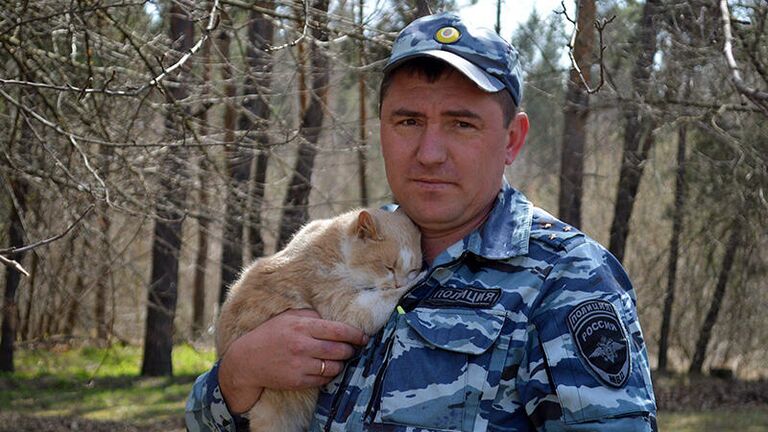 Начальник Центра кинологической службы УМВД России по городу Старому Осколу Сергей Коровин и кот Жулик