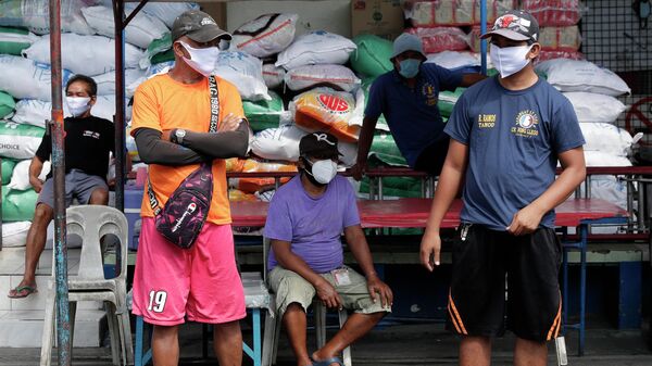 Местные жители в защитных масках на улице Манилы, Филиппины