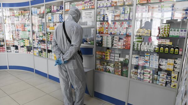 Человек в защитном костюме в одной из аптек Симферополя