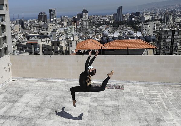 Тунисская профессиональная танцовщица тренируется на крыше своего жилого дома в пригороде Декване, Бейрут