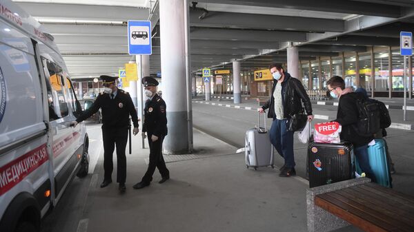 Сотрудники полиции и пассажиры, прибывшие рейсом компании Аэрофлот из Нью-Йорка, в Международном аэропорту Шереметьево