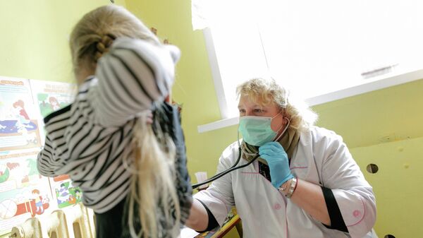 Врач осматривает ребенка, проверяет работу дыхательной системы, в детском саду № 15 в Иваново
