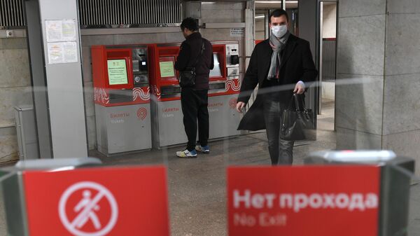 Пассажир у турникета на станции метро Сходненская в Москве