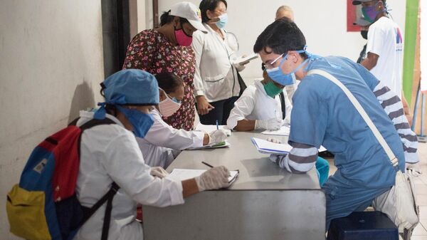 Медики и жители перед тестированием на коронавирус в Каракасе
