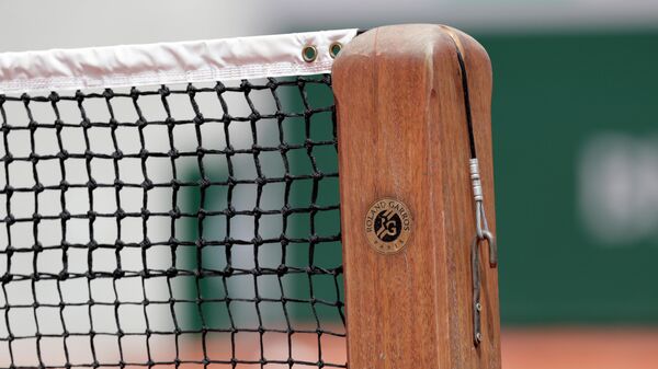 Close-up of the Roland Garros logo displayed on the net of a court, on day two of The Roland Garros 2019 French Open tennis tournament in Paris on May 27, 2019. (Photo by Thomas SAMSON / AFP)