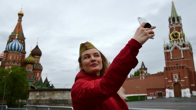 Женщина делает селфи на Красной площади в Москве во время празднования Дня Победы