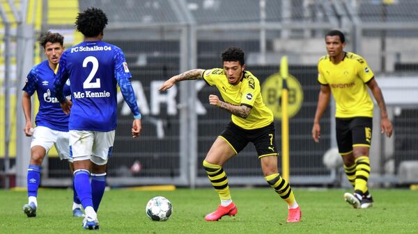 Dortmund's English midfielder Jadon Sancho vies for the ball during the German first division Bundesliga football match BVB Borussia Dortmund v Schalke 04 on May 16, 2020 in Dortmund, western Germany as the season resumed following a two-month absence due to the novel coronavirus COVID-19 pandemic. (Photo by Martin Meissner / POOL / AFP) / DFL REGULATIONS PROHIBIT ANY USE OF PHOTOGRAPHS AS IMAGE SEQUENCES AND/OR QUASI-VIDEO