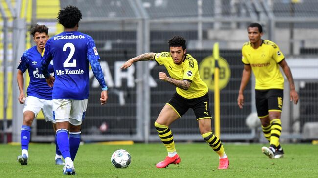 Dortmund's English midfielder Jadon Sancho vies for the ball during the German first division Bundesliga football match BVB Borussia Dortmund v Schalke 04 on May 16, 2020 in Dortmund, western Germany as the season resumed following a two-month absence due to the novel coronavirus COVID-19 pandemic. (Photo by Martin Meissner / POOL / AFP) / DFL REGULATIONS PROHIBIT ANY USE OF PHOTOGRAPHS AS IMAGE SEQUENCES AND/OR QUASI-VIDEO