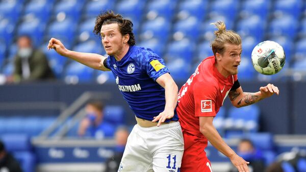 Schalke's Austrian forward Michael Gregoritsch (L) and Augsburg's Croation defender Tin Jedvaj jump for the ball during the German first division Bundesliga football match FC Schalke 04 v FC Augsburg on May 24, 2020 in Gelsenkirchen, western Germany. (Photo by Martin Meissner / POOL / AFP) / DFL REGULATIONS PROHIBIT ANY USE OF PHOTOGRAPHS AS IMAGE SEQUENCES AND/OR QUASI-VIDEO