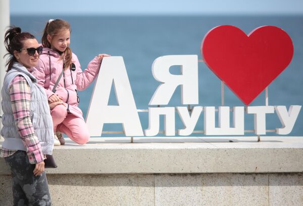 Женщина с ребенком на набережной Алушты после отмены режима самоизоляции в Крыму