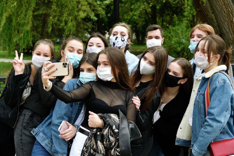 Выпускники средней школы фотографируются после празднования последнего звонка в парке Гагарина в Симферополе