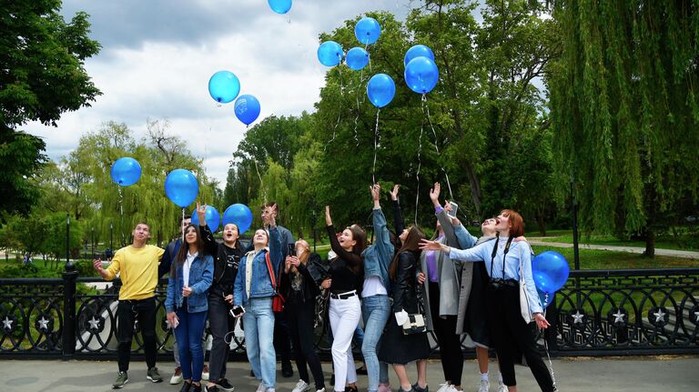 Выпускники средней школы отпускают воздушные шары после празднования последнего звонка в парке Гагарина в Симферополе