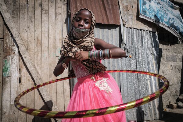 Девочка крутит обруч в Центре доброй надежды Марказил Банатил Исламия в Найроби, Кения