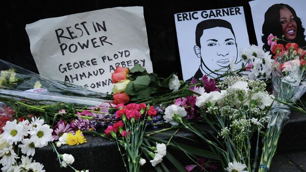 NEW YORK, NEW YORK - MAY 29: Flowers and pictures lay at a memorial to victims of police violence during a demonstration in front of a Manhattan court house and jail to protest the recent death of George Floyd on May 29, 2020 in New York City. Minneapolis Police officer Derek Chauvin was filmed kneeling on Floyd's neck. Floyd was later pronounced dead at a local hospital. Across the country, protests against Floyd's death have set off days and nights of rage as its the most recent in a series of deaths of black Americans by the police.   Spencer Platt/Getty Images/AFP