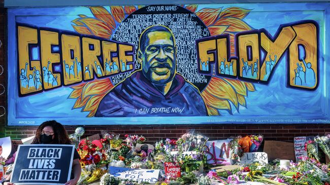 Flowers, signs and balloons are left near a makeshift memorial to George Floyd near the spot where he died while in custody of the Minneapolis police, on May 29, 2020 in Minneapolis, Minnesota. - Demonstrations are being held across the US after George Floyd died in police custody on May 25. (Photo by Kerem Yucel / AFP)