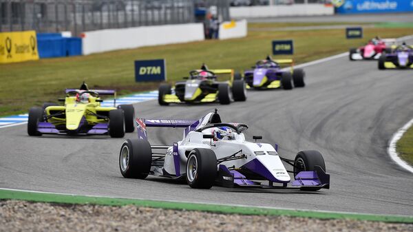 British motor racing driver Jamie Chadwick (R) leads to win in her Tatuus F3 T-318 ahead of compatriot Alice Powell and Marta Garcia during the W Series motor racing event on the Hockenheimring, south-western Germany on May 4, 2019. (Photo by Hasan Bratic / dpa / AFP) / Germany OUT