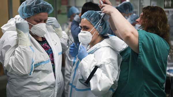 Врачи городской клинической больницы № 15 имени О. М. Филатова в Москве переодеваются в защитные костюмы перед сменой