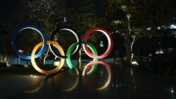 A night view of the closed Olympic museum with the Olympic Rings is seen in Tokyo on April 2, 2020. (Photo by Philip FONG / AFP)