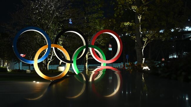 A night view of the closed Olympic museum with the Olympic Rings is seen in Tokyo on April 2, 2020. (Photo by Philip FONG / AFP)