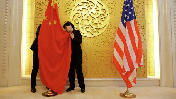 Служащие устанавливают флаг Китая перед встречей министров транспорта КНР и США
