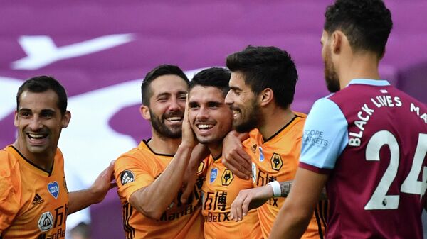 Wolverhampton Wanderers' Portuguese midfielder Pedro Neto (C) celebrates scoring their second goal during the English Premier League football match between West Ham United and Wolverhampton Wanderers at The London Stadium, in east London on June 20, 2020. (Photo by Ben STANSALL / POOL / AFP) / RESTRICTED TO EDITORIAL USE. No use with unauthorized audio, video, data, fixture lists, club/league logos or 'live' services. Online in-match use limited to 120 images. An additional 40 images may be used in extra time. No video emulation. Social media in-match use limited to 120 images. An additional 40 images may be used in extra time. No use in betting publications, games or single club/league/player publications. / 