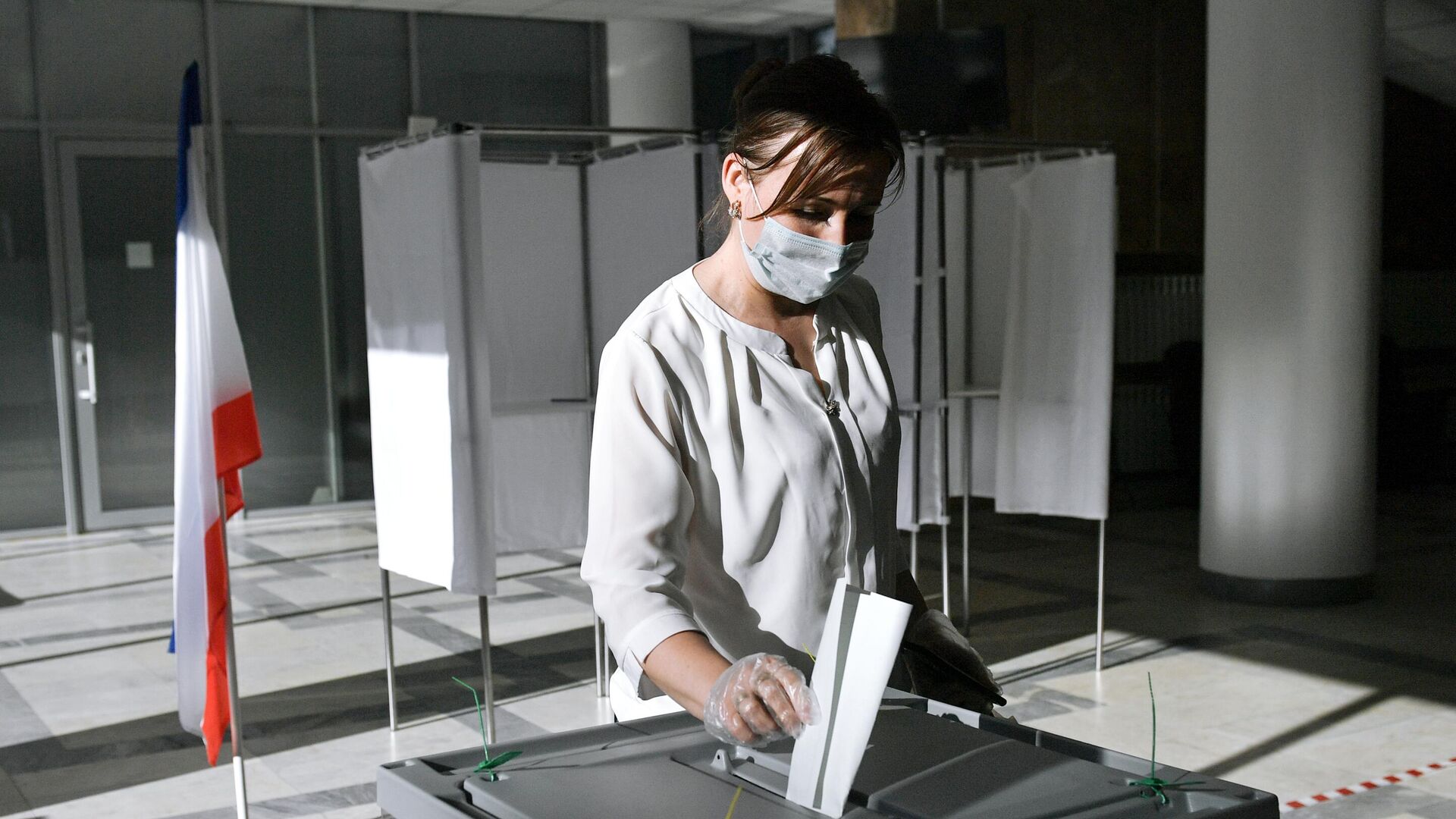 Женщина голосует по одобрению внесения поправок в Конституцию РФ на избирательном участке в Симферополе - РИА Новости, 1920, 13.09.2020