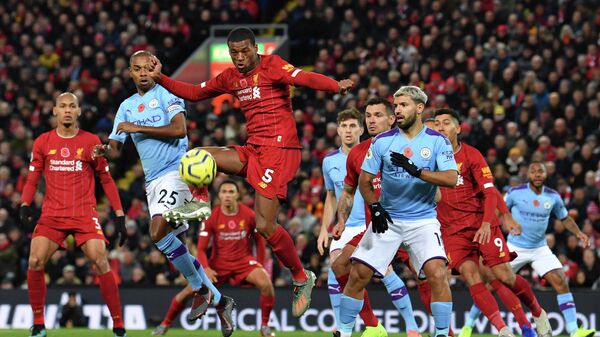 Liverpool's Dutch midfielder Georginio Wijnaldum (C) controls the ball during the English Premier League football match between Liverpool and Manchester City at Anfield in Liverpool, north west England on November 10, 2019. (Photo by Paul ELLIS / AFP) / RESTRICTED TO EDITORIAL USE. No use with unauthorized audio, video, data, fixture lists, club/league logos or 'live' services. Online in-match use limited to 120 images. An additional 40 images may be used in extra time. No video emulation. Social media in-match use limited to 120 images. An additional 40 images may be used in extra time. No use in betting publications, games or single club/league/player publications. / 
