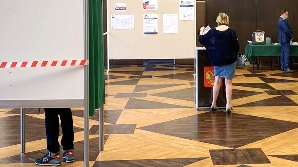 Женщина принимает участие в голосовании по внесению поправок в Конституцию РФ на избирательном участке в посольстве Российской Федерации в Париже