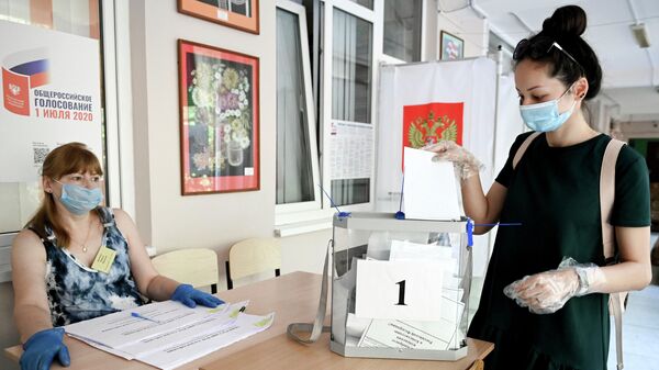 Девушка принимает участие в голосовании по внесению поправок в Конституцию РФ