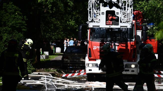 Сотрудники противопожарной службы у жилого дома на северо-востоке Москвы, где произошел хлопок газа