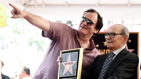 Итальянский композитор Эннио Морриконе с режиссером Квентином Тарантино во время церемонии вручения Морриконе звезды на Голливудской Аллее Славы в Лос-Анджелесе. 2016 год