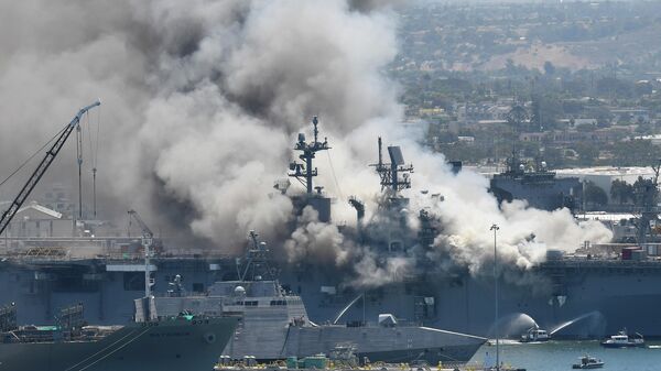 Smoke rises from the USS Bonhomme Richard at Naval Base San Diego Sunday, July 12, 2020, in San Diego after an explosion and fire Sunday on board the ship at Naval Base San Diego