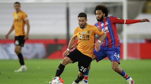 Crystal Palace's Dutch defender Jairo Riedewald (R) vies for the ball against Wolverhampton Wanderers' Portuguese midfielder Joao Moutinho (C) during the English Premier League football match between Wolverhampton Wanderers and Crystal Palace at the Molineux stadium in Wolverhampton, central England  on July 20, 2020. (Photo by Martin Rickett / POOL / AFP) / RESTRICTED TO EDITORIAL USE. No use with unauthorized audio, video, data, fixture lists, club/league logos or 'live' services. Online in-match use limited to 120 images. An additional 40 images may be used in extra time. No video emulation. Social media in-match use limited to 120 images. An additional 40 images may be used in extra time. No use in betting publications, games or single club/league/player publications. / 