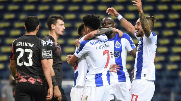 FC Porto's Brazilian midfielder Otavinho celebrates with teammates after scoring a goal during the Portuguese League football match FC Porto against Moreirense FC at the Dragao stadium in Porto on July 20, 2020. (Photo by MIGUEL RIOPA / AFP)