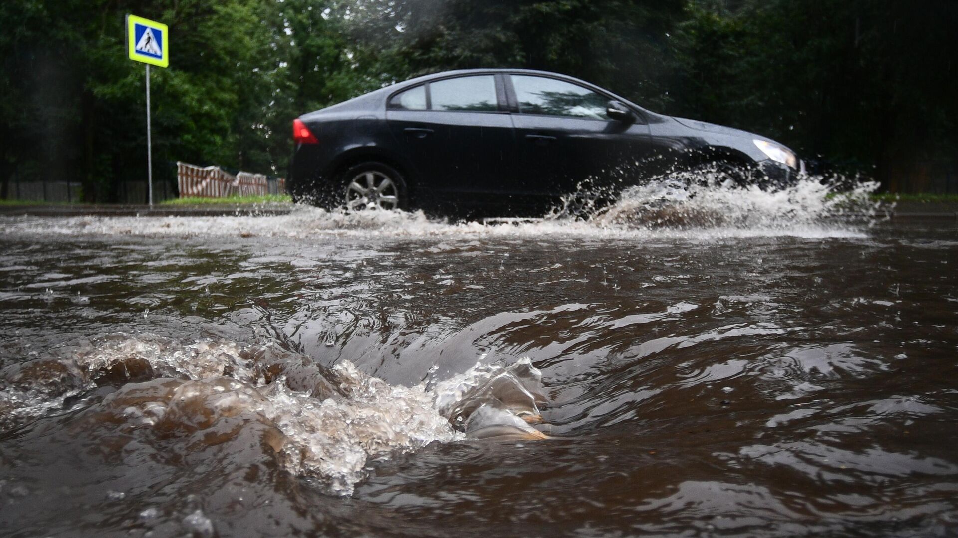 Автомобиль едет по подтопленной из-за дождя дороге в Москве - РИА Новости, 1920, 18.09.2020