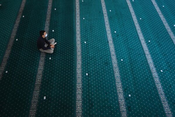 Верующий перед началом праздничной молитвы в Соборной мечети Новосибирска