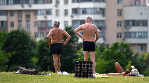 Люди отдыхают в жаркий день в парке на Ходынском поле в Москве