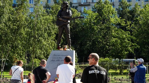 Люди у памятника лидеру группы Кино Виктору Цою скульптора Матвея Макушкина в Санкт-Петербурге
