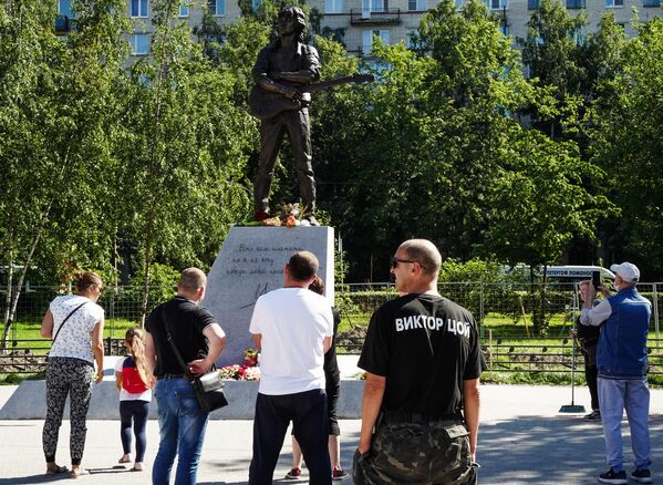 Люди у памятника лидеру группы Кино Виктору Цою скульптора Матвея Макушкина в Санкт-Петербурге